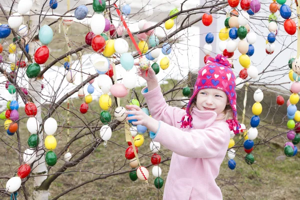 Little girl standing by Easter tree — Stock Photo, Image