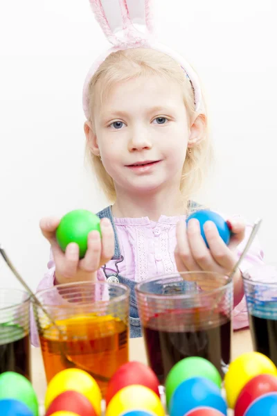 Portrait of little girl during Easter eggs'' coloration — Stock Photo, Image