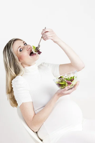 Mulher grávida comendo salada — Fotografia de Stock