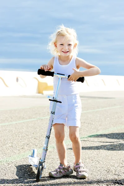 Little girl with a scooter — Stock Photo, Image