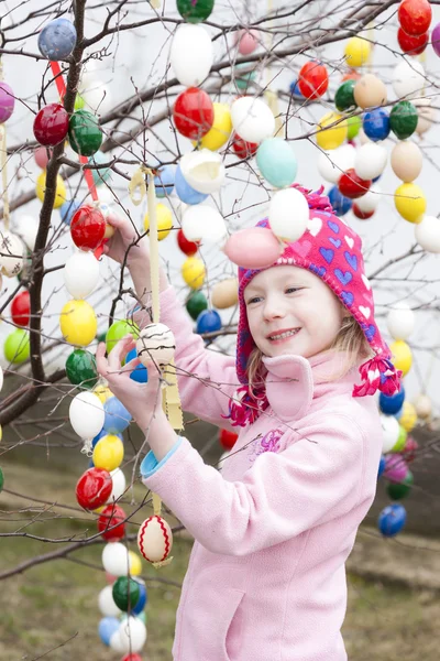 Little girl standing by Easter tree — Stock Photo, Image
