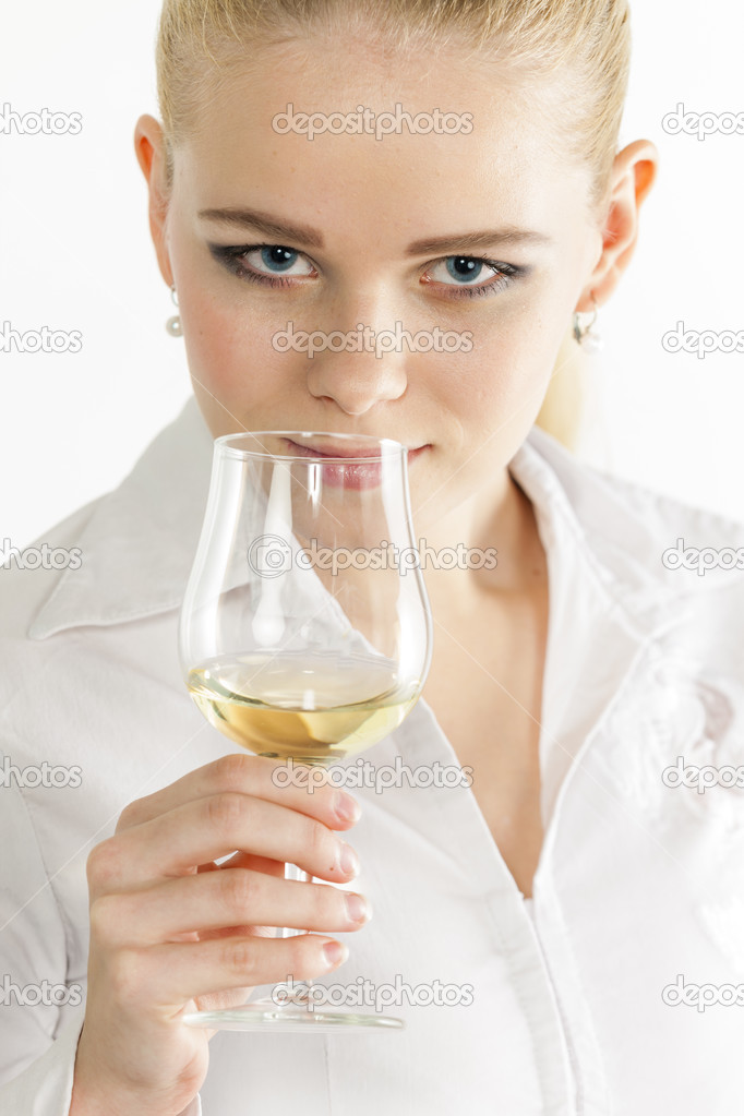 Young woman tasting white wine