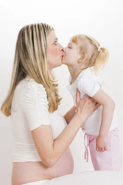 Portrait of little girl with her pregnant mother — Stock Photo, Image