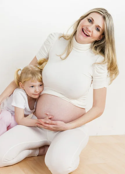 Niña con su madre embarazada — Foto de Stock