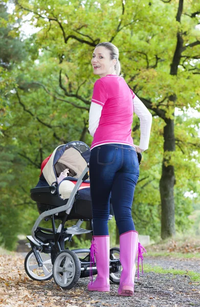 Woman with a pram — Stock Photo, Image