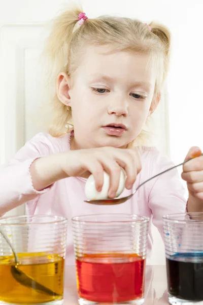 Little girl coloring Easter eggs — Stock Photo, Image