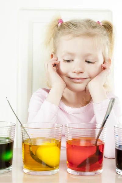 Little girl during Easter eggs' coloration — Stock Photo, Image