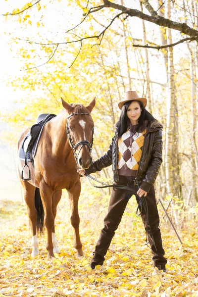 Ridsport med sin häst i höst natur — Stockfoto