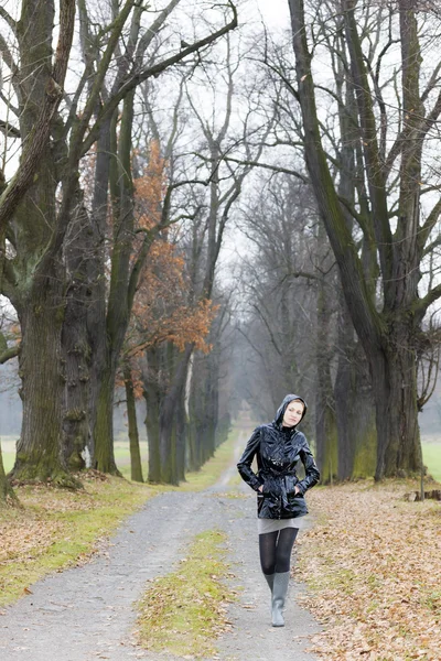 Frau trägt Gummistiefel in herbstlicher Gasse — Stockfoto