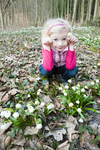 Meisje met sneeuwvlokken in de lente natuur — Stockfoto