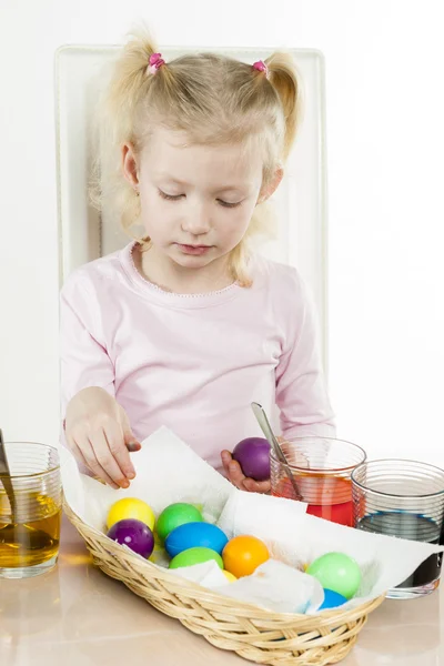 Portrait of little girl during Easter eggs' coloration — Stock Photo, Image