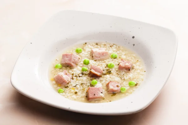 Smoked meat bouillon with pearl barley and peas — Stock Photo, Image