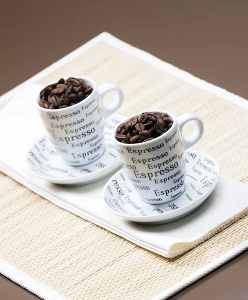 Coffee cups full of coffee beans — Stock Photo, Image