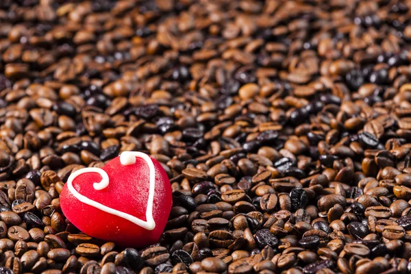 Still life of coffee beans and marzipan heart — Stock Photo, Image