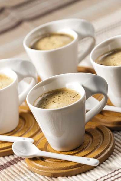 Cups of coffee on place mats — Stock Photo, Image