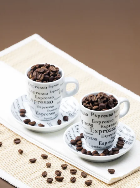 Coffee cups full of coffee beans — Stock Photo, Image