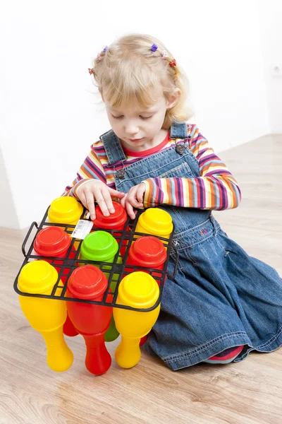 Little girl playing with skittles — Stock Photo, Image