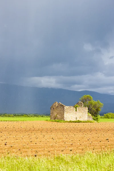 Field with a ruin — Stock Photo, Image