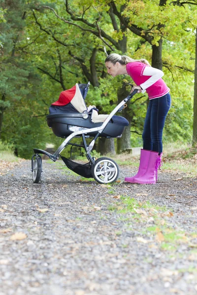 Woman with a pram — Stock Photo, Image