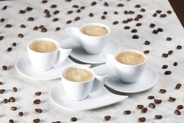 Four cups of coffee with milk — Stock Photo, Image