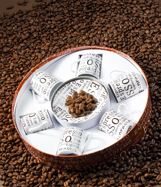 Cups on coffee beans — Stock Photo, Image