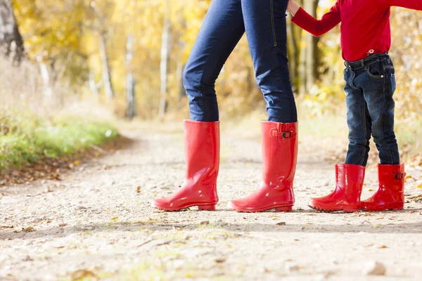 Mother and daughter wearing rubber boots — Stock Photo, Image
