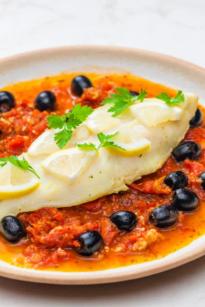 cod on tomato sauce with black olives