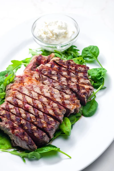Hovězí Steak Česnekovou Omáčkou Špenátem Listy Rukoly — Stock fotografie