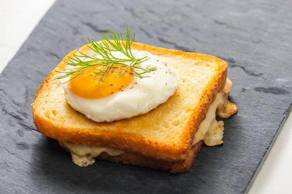 toast with cheese served with fried egg