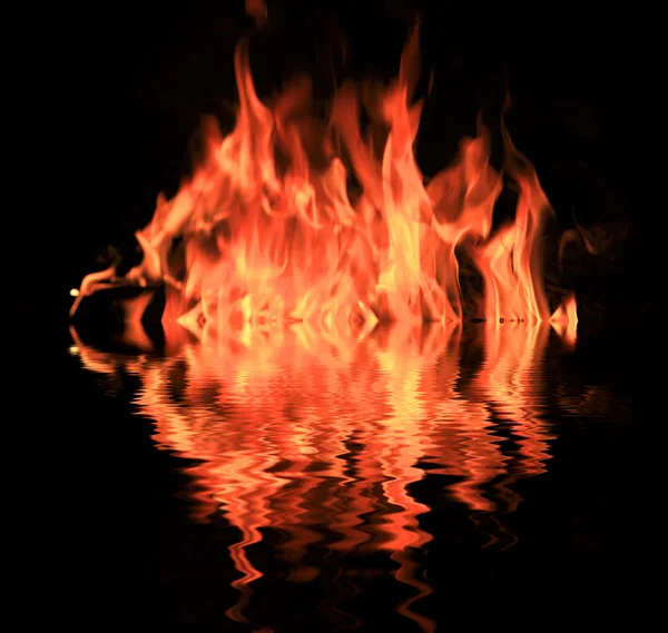 Fire in darkness with water reflection — Stock Photo, Image