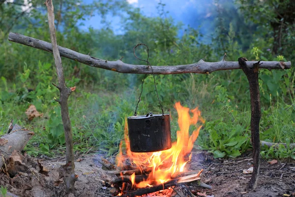 Tourist kettle on camp fire — Stock Photo, Image