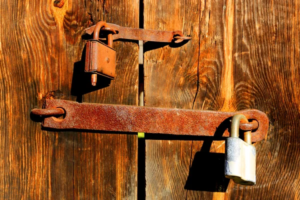 Locks on wooden door — Stock Photo, Image