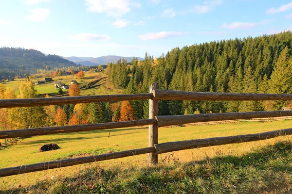 Authumn landscape with wooden fence on meadow in Carpathians, Ukriane