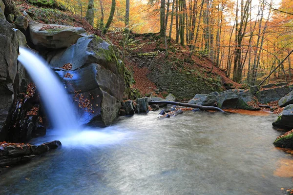 Landscape with waterfall on mountain river in autumn forest. Take it in Ukraine