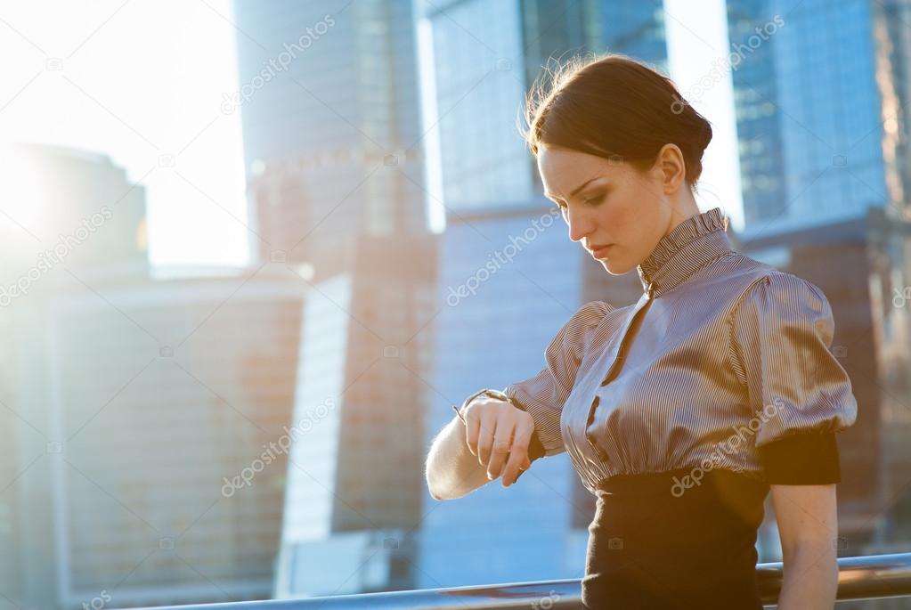 Business woman checking the time