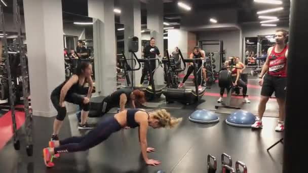 Deportistas haciendo ejercicio en un gimnasio moderno — Vídeo de stock