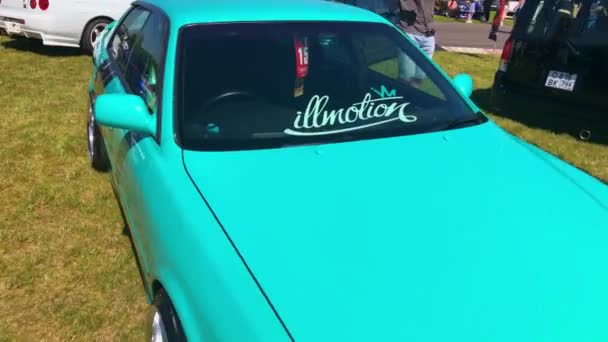 Turquoise car during festival on summer day — Stock Video