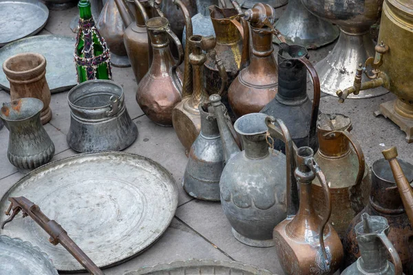 Alte Kupferwaren auf Pflaster gelegt — Stockfoto