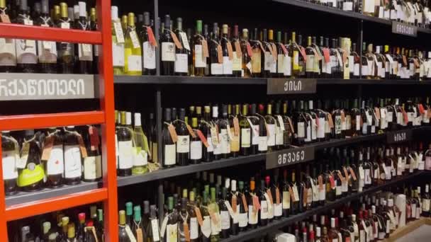 Shelves with bottles in wine shop — Stock Video