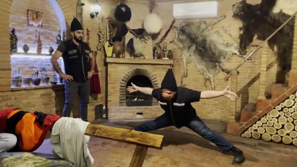 Caucasian man drinking and dancing in traditional house — Vídeo de Stock