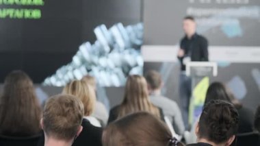 İş semineri sırasında izleyiciler sunumu izliyor