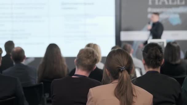 Audience watching presentation during business seminar — 图库视频影像