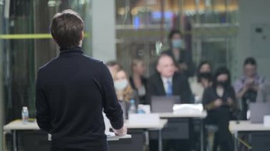 Male speaker talking to audience