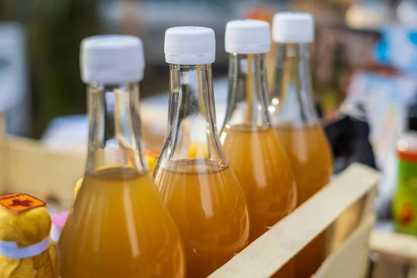 Fresh drinks in glass bottles on market — Stock Photo, Image