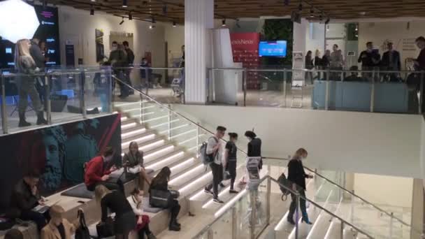 People walking down stairs in business center — Stock Video