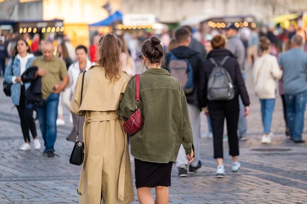 Girlfriends walking during festival in park