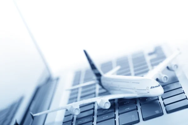 Model plane on laptop keyboard — Stock Photo, Image