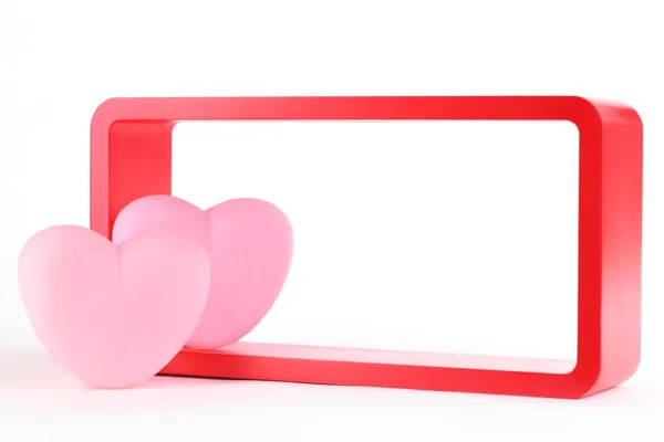 Рожеві серця з червоною дерев'яною рамкою — стокове фото