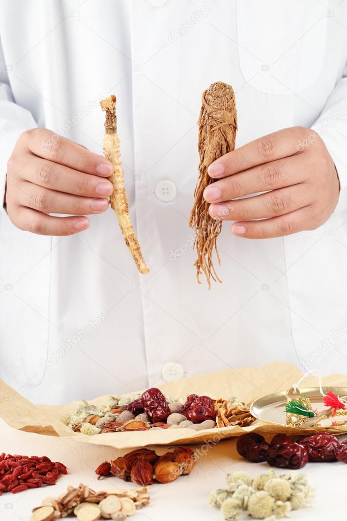 Doctor showing Chinese traditional herbal medicine.