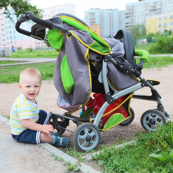 Child outdoors with the stroller Royalty Free Stock Images